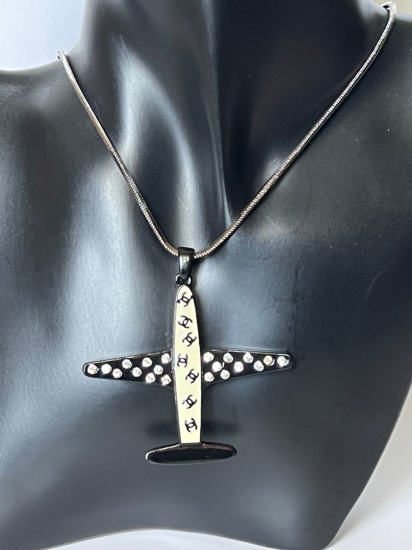 Silver Necklace with a Black and White Airplane Pendant