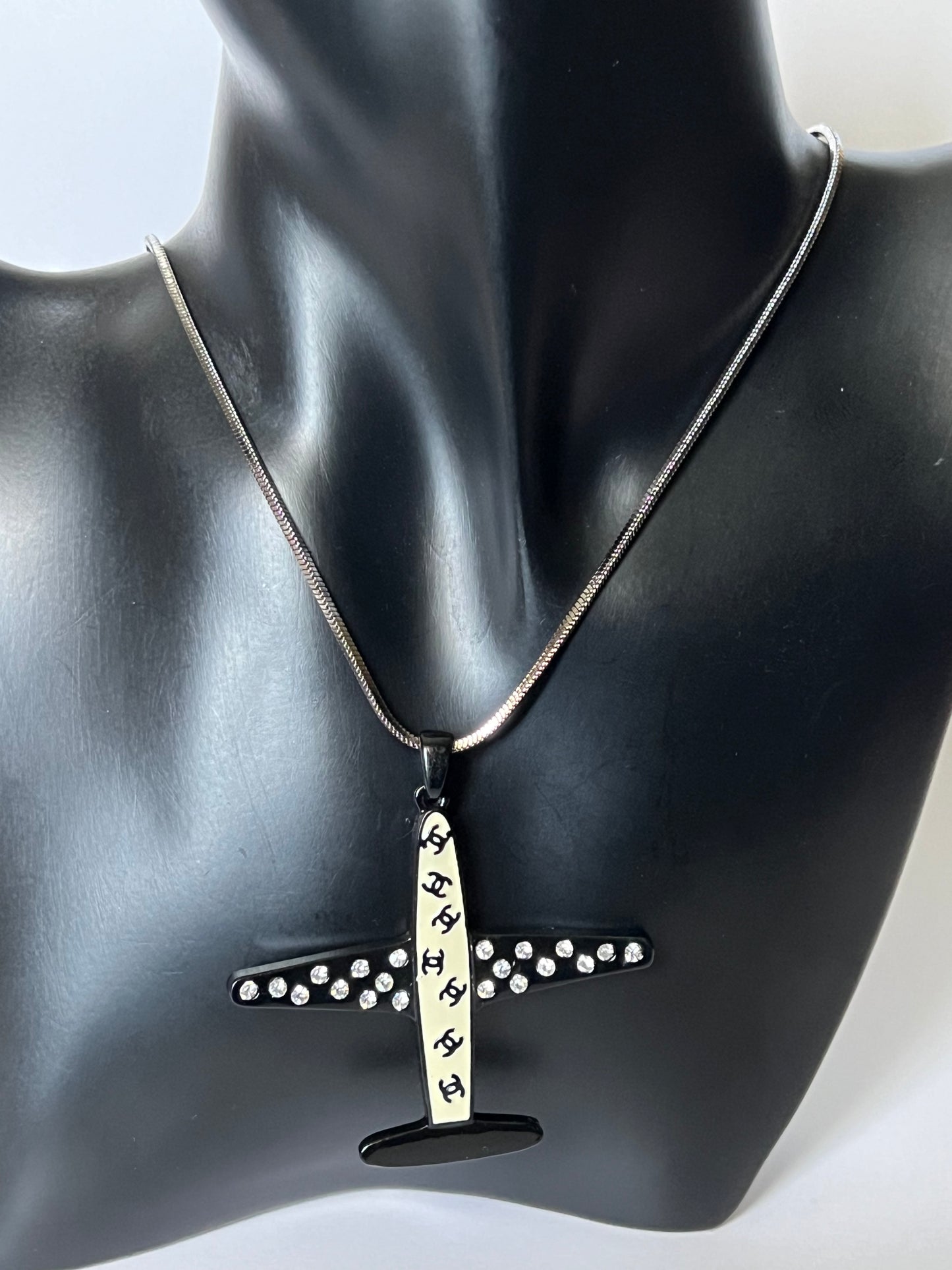 Silver Necklace with a Black and White Airplane Pendant