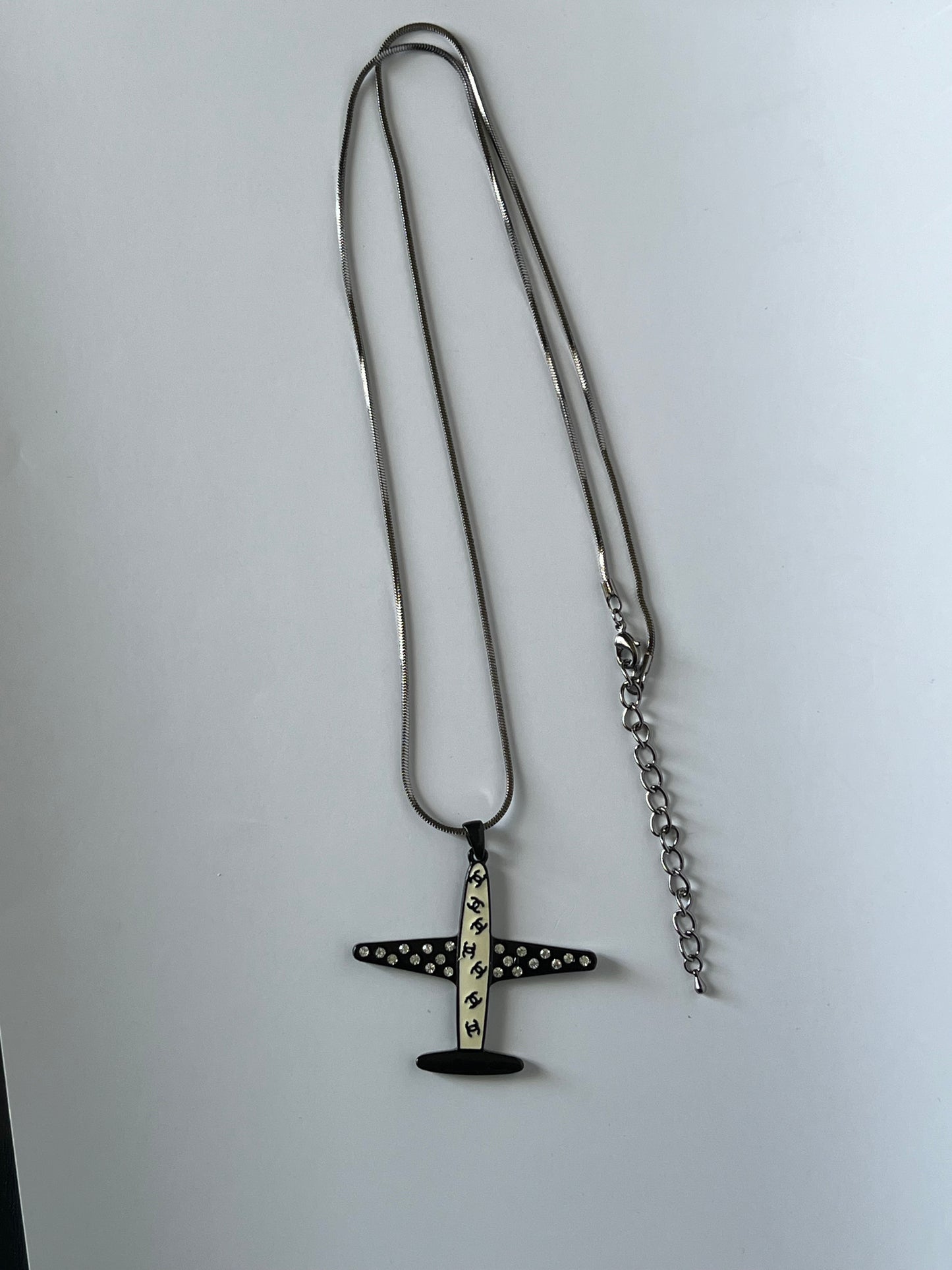 Silver Necklace with a Black and White Airplane Pendant